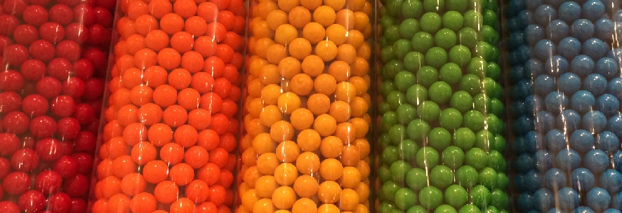 image of gumballs in five tall cylindrical containers, in rainbow order of color, photo credit Eric Weeks
